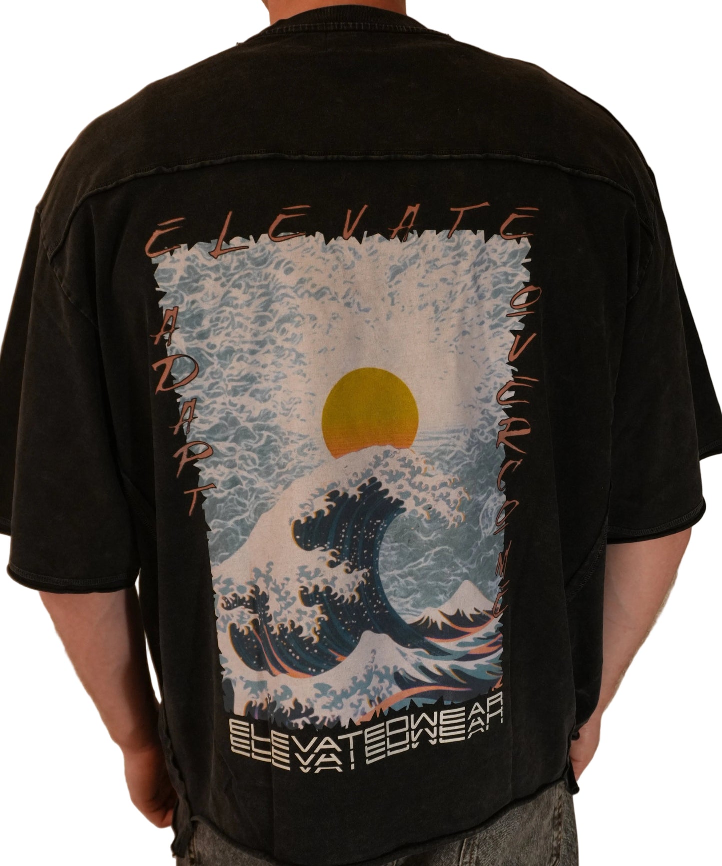 Black backpack with a design of a wave and sun held by a person.