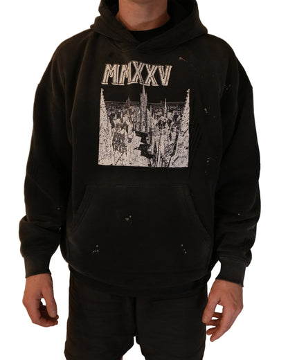 Person wearing a black hoodie with a graphic design on a plain background
