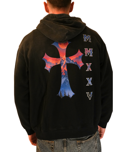 Black hoodie with a colorful cross design and 'MMXV' on the back, worn by a person.