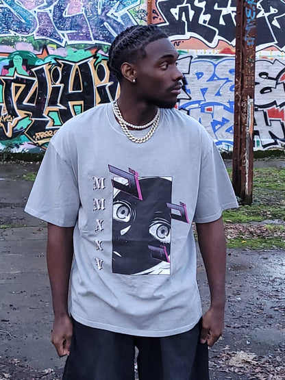 Person wearing a graphic t-shirt in front of a graffiti-covered wall